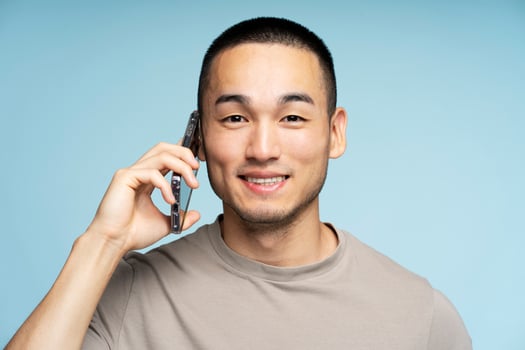 Young man smiling while talking on the phone photo