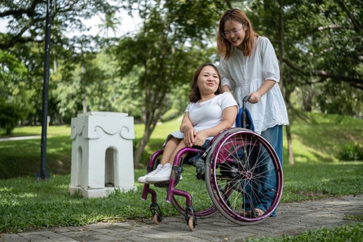 Young Disabled Woman and Her Best Friend Enjoying Outdoor Activities Together in a Park Setting photo