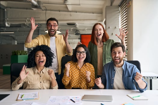 Excited team of business people celebrating success in office photo