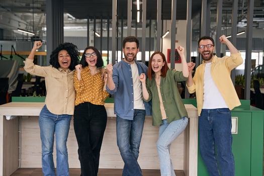 Successful business team celebrating victory in modern office photo