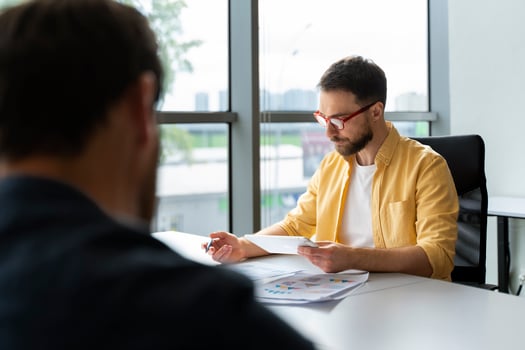 Businessman analyzing financial data on tablet in office meeting photo