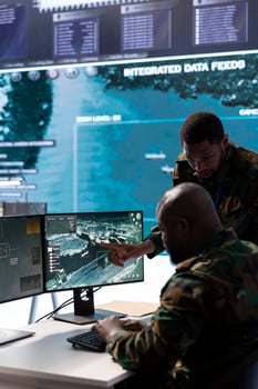 In a high tech military office, soldiers team analyze real time data collected by cctv surveillance system. Staff interpret intelligence and coordinate operations to ensure national defense mission. photo