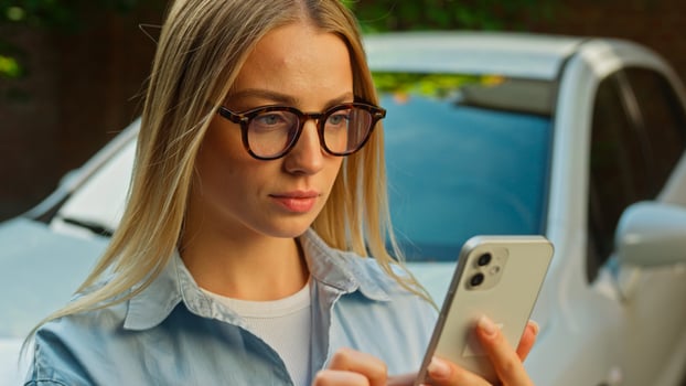 Caucasian woman businesswoman using mobile phone smartphone message notification good news enjoy victory winning success luck new car automobile girl auto achievement emotions amaze wow online female photo