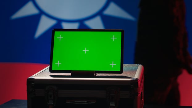 Taiwan army commander devising strategy to combat Chinese propaganda next to green screen tablet. Taiwanese freedom fighter walking in operation room in front of mockup device, camera A photo