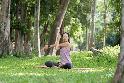 Woman Practicing Yoga in a Serene Park Setting, Relaxing and Meditating Outdoors in Nature photo