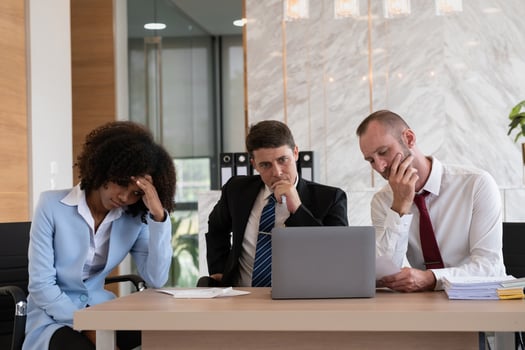 Diverse business team contemplating at office desk, Concept of strategic decision-making photo