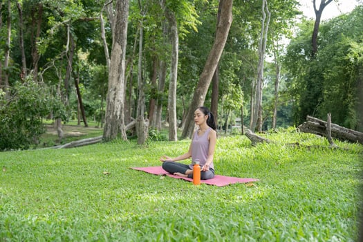 Young Woman Practicing Yoga Outdoors in a Serene Garden Setting, Embracing Nature and Tranquility photo