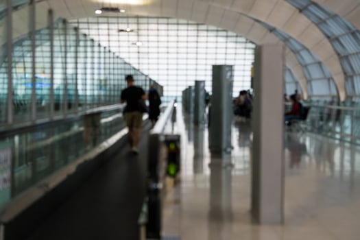 Blurred people walking on the walkway airport at airport. photo