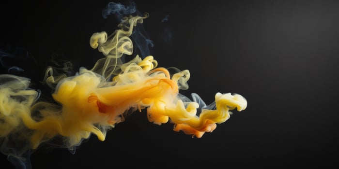 Yellow and orange smoke in water on a black background photo