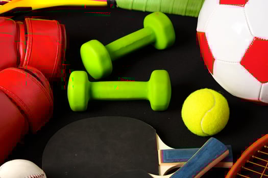 Various sports equipment on black background studio shot photo