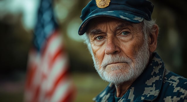 Elderly veteran stands proudly near American flag. An elderly veteran gazes thoughtfully while standing next to an American flag, showcasing his pride and dedication to service. photo