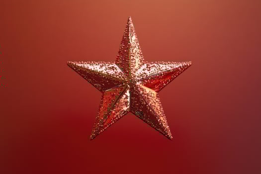 A Glittering Red Star Ornament Against a Red Background photo
