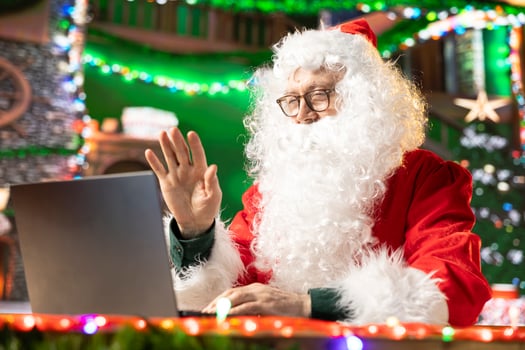 Saint Nicholas talking to parents and kids before Christmas eve, using web call to find out about gift wishes. Modern Santa using technology to make children happy, x mas cheer. photo