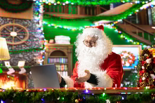 Father Christmas meeting with parents on internet videocall before the winter holiday celebration, discussing about gifts ideas to make children happy on x mas. Santa using technology. photo