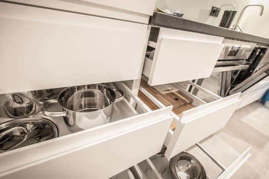 Modern Kitchen With Open Drawers Showcasing Organized Cooking Pots and Utensils in a Sleek Design photo
