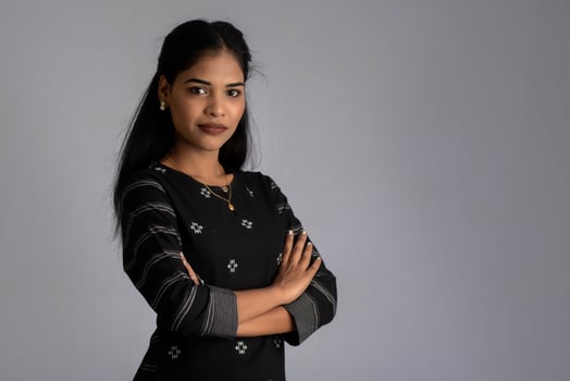 Portrait of a young beautiful cute cheerful girl smiling looking at the camera on gray background photo