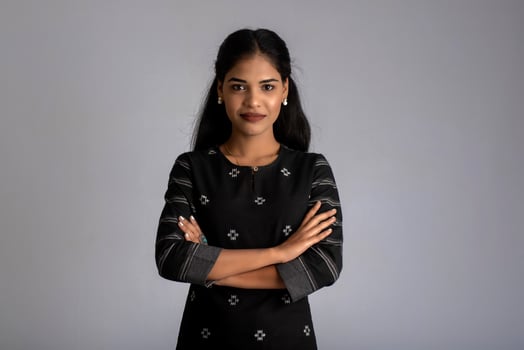 Portrait of a young beautiful cute cheerful girl smiling looking at the camera on gray background photo