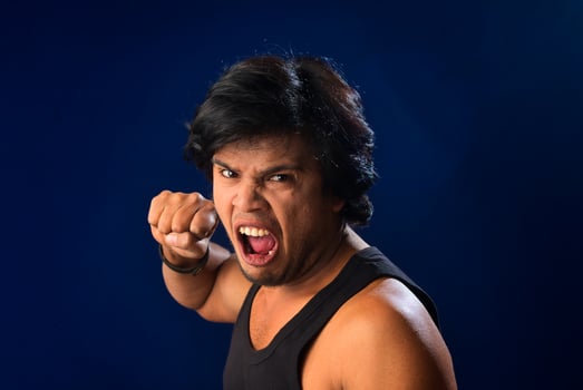Portrait of a young man posing and showing his muscular body. The concept of a healthy lifestyle on blue background. photo