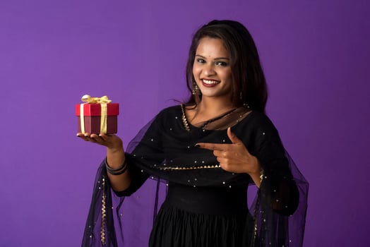 Portrait of young happy smiling woman or Girl holding gift box. photo