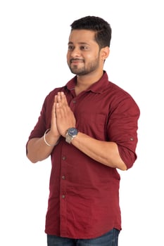 Young Indian man with welcome expression or inviting or greeting Namaste on a white background photo