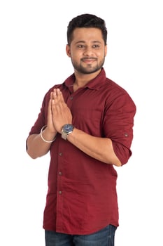 Young Indian man with welcome expression or inviting or greeting Namaste on a white background photo