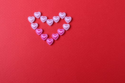 heart of rhinestone hearts on a red bright background with a copy of the space place for text valentine's day photo