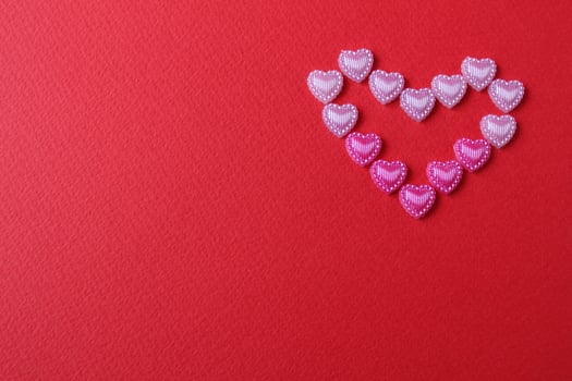 heart of rhinestone hearts on a red bright background with a copy of the space place for text valentine's day photo
