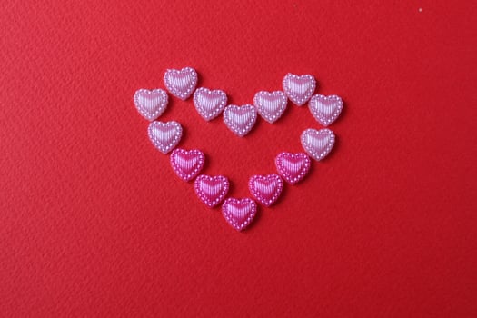 heart of rhinestone hearts on a red bright background with a copy of the space place for text valentine's day photo