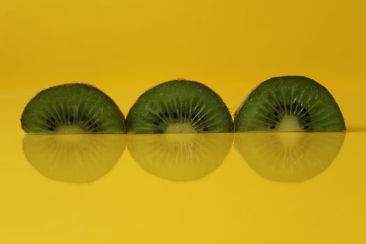 pieces of kiwi halves with a trend of Illuminating yellow color with a place to insert a copyspace photo