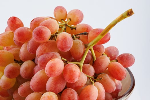 A juicy beautiful bunch of grapes lies in a plate. photo