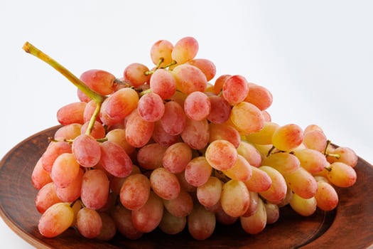 A juicy beautiful bunch of grapes lies in a plate. photo
