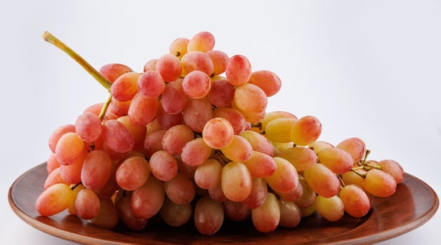 A juicy beautiful bunch of grapes lies in a plate. photo
