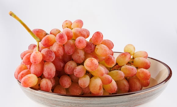 A juicy beautiful bunch of grapes lies in a plate. photo