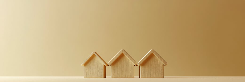 Wooden model houses on a smooth surface with a warm background in a calm interior setting photo