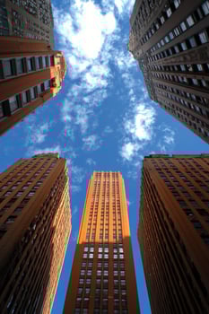 Skyscrapers reaching for the blue sky in a vibrant urban landscape during daylight hours photo