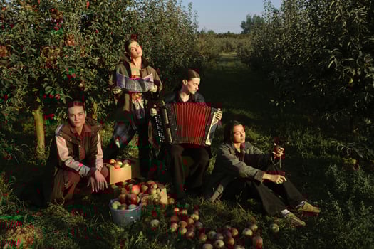 Four stylish girls have fun celebrating the apple harvest at sunset. Fashionable models at the fall apple harvest photo