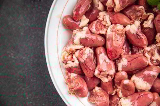 Chicken heart raw chicken offal tasty food dish Fresh delicious gourmet food background on the table rustic food top view copy space top view keto and paleo diet photo