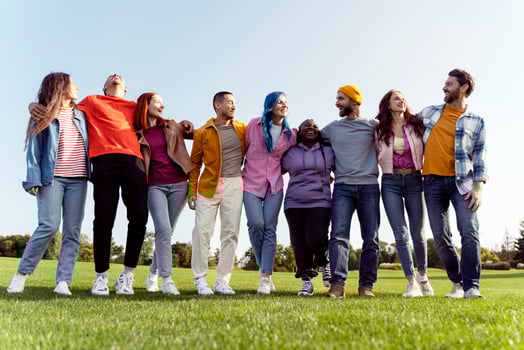 Group of diverse people embracing diversity outdoors photo