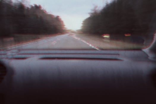 Blurred unfocused view through the moving car windscreen. Glitch retro effect. photo