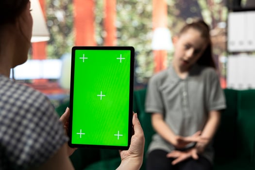 Teenager undergoing therapy for depression next to isolated chroma key screen, asking advice to boost self esteem. Psychologist expert guiding her to overcome her internal frustration. photo