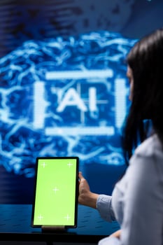 Admin running AI cognitive computing tech on mockup tablet to simulate computerized model. Close up of green screen device used by IT specialist to do data mining with artificial intelligence photo