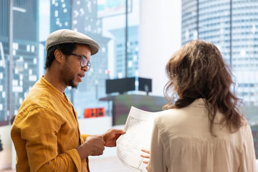 Client sharing her office space layout vision with real estate agent, planning to sign a leasing contract for the high class property. Realtor showing the design during a office tour. photo
