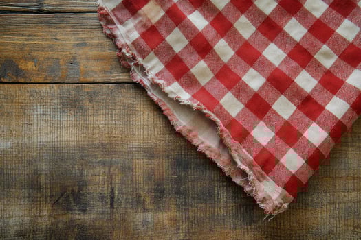 A red and white checkered cloth on a wooden table photo