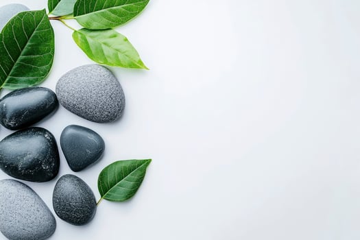 Spa stones and leaves on white background photo