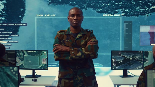 Portrait of confident military general wearing camo uniform in mission control center, overseeing operations regarding the national safety and protocol. Federal army base command post. Camera B. photo