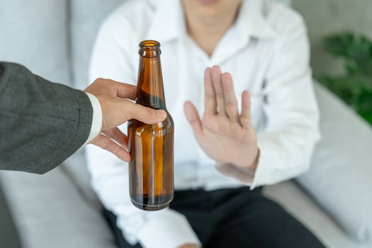 man refuses say no and avoid to drink an alcohol whiskey, stopping hand sign male, alcoholism treatment, alcohol addiction, quit booze, Stop Drinking Alcohol. Refuse Glass liquor, unhealthy, reject photo