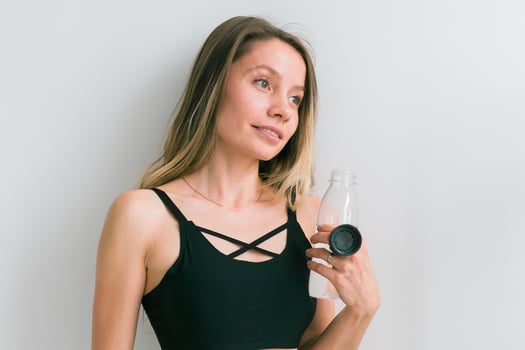Sporty young woman drinking water after training. Active lifestyle and wellness photo