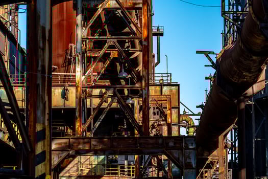 Rusty industrial structure with pipes and metal beams in an abandoned factory photo