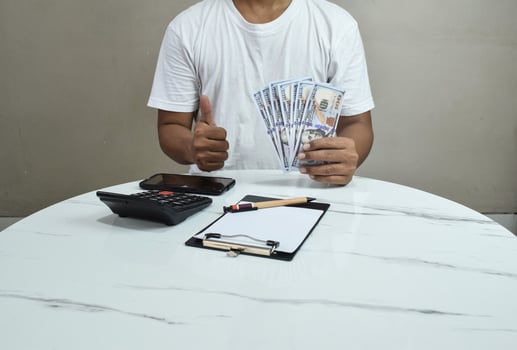 finances, economy and business concept. close up of Businessman with money on hand photo