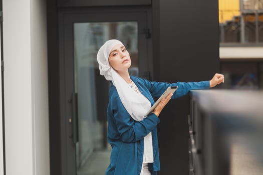 Modern Arabian muslim woman with tablet computer outdoors photo